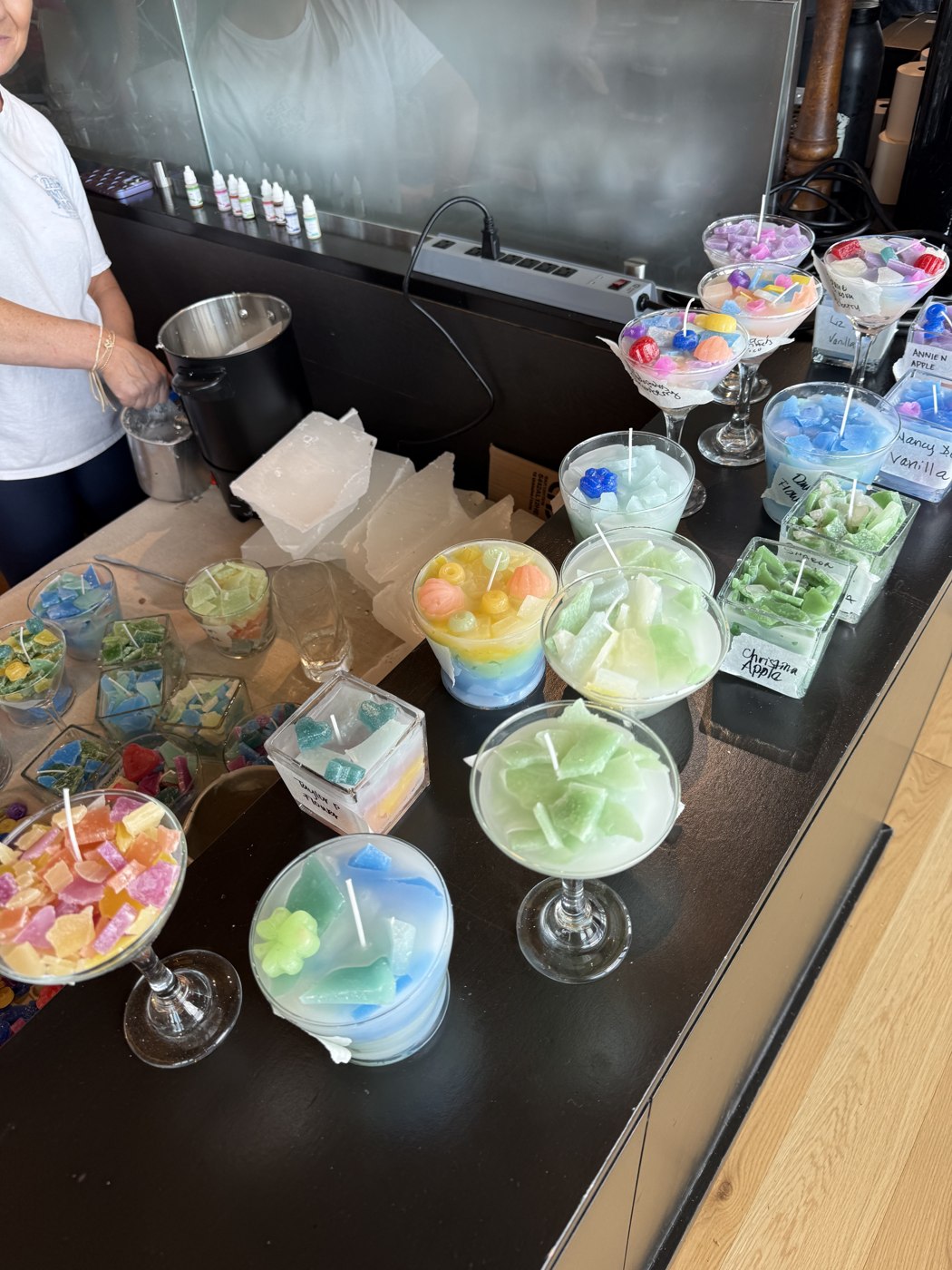 Colorful handmade candles with wax shapes and toppings