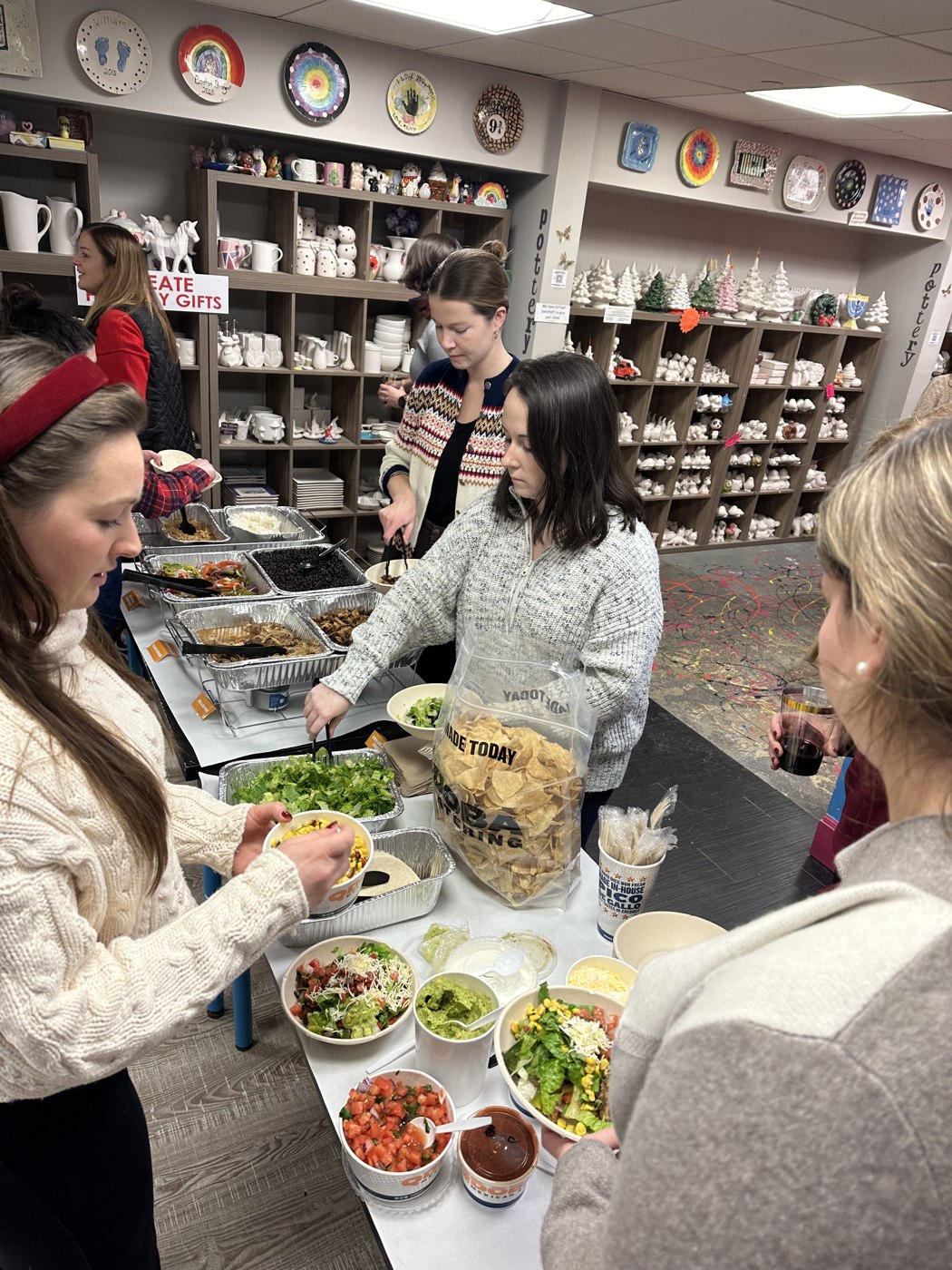 Adult guests enjoying food together during a studio group event