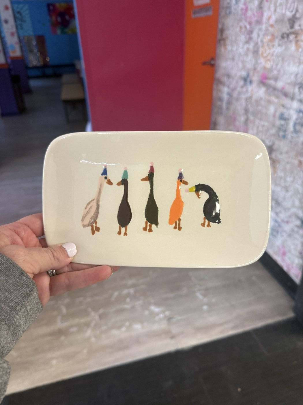 Hand-painted tray with a row of colorful cats
