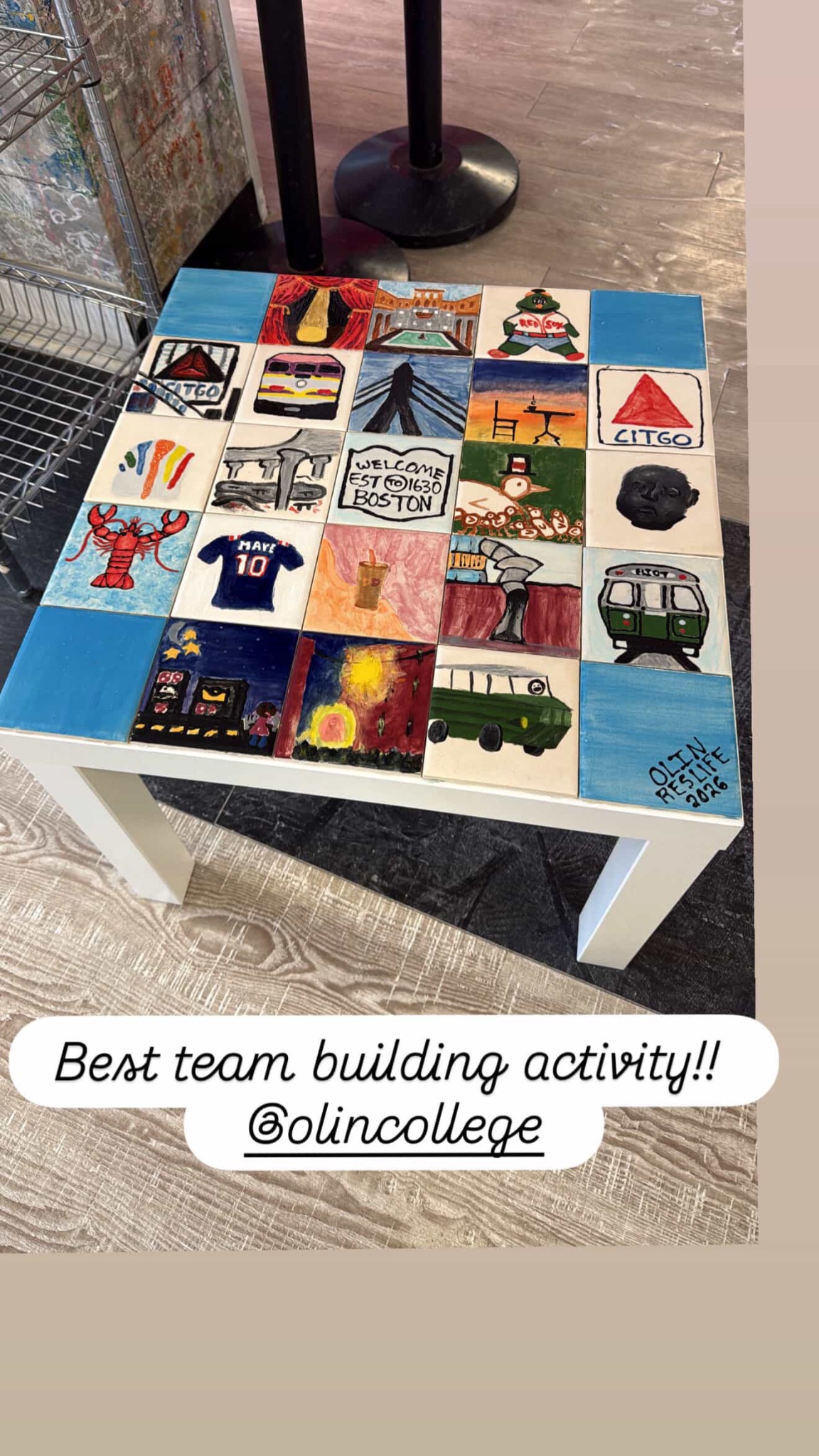 A finished team tile table with individually painted Boston-themed tiles