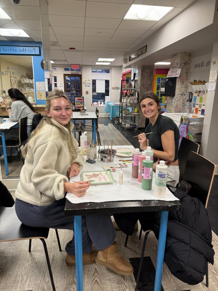 Two friends painting together at The Painting Place